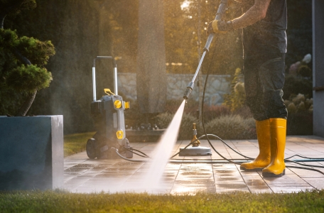 Technician pressure washing patio for a cottage in Put-In-Bay, Ohio